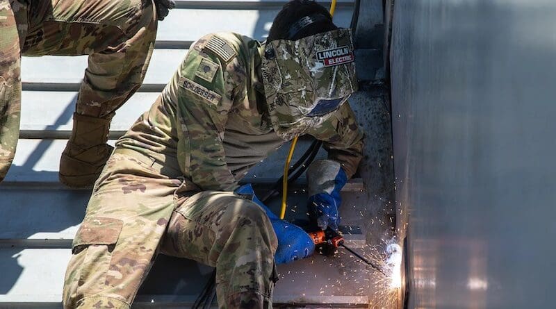 A soldier assigned to the Army’s 86th Engineer Dive Detachment, 20th Engineer Brigade, welds the bow ramp of a landing craft utility vessel as part of repair operations for the Joint Logistics Over-the-Shore pier at the Port of Ashdod, Israel. Photo Credit: DOD