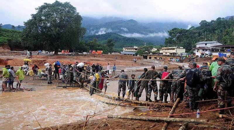 Army soldiers help trapped people to cross a temporary bridge at a landslide site after multiple landslides in the hills in Wayanad district, in the southern state of Kerala, India. Photo Credit: Chin pin choo, Wikipedia Commons