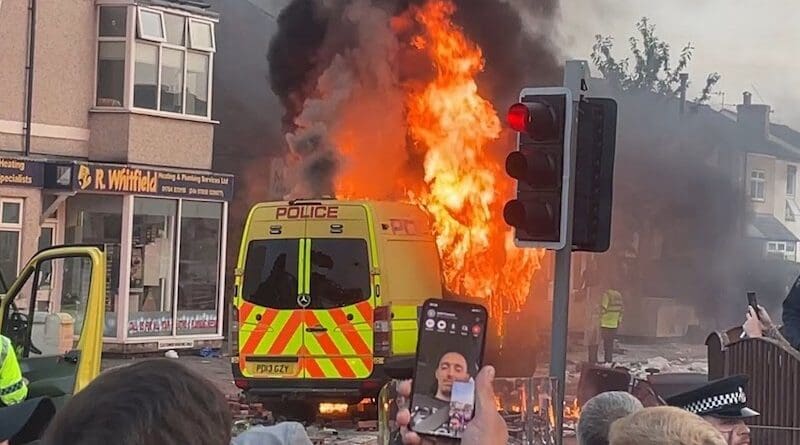 A police van on fire during the 2024 Southport Riots. Photo Credit: StreetMic LiveStream, Wikipedia Commons