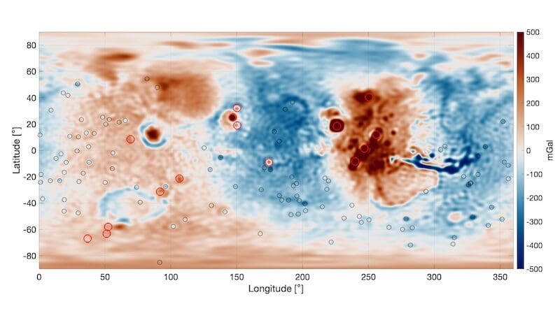 Gravity map of Mars. The red circles show prominent volcanoes on Mars and the black circles show impact crates with a diameter larger than a few 100 km. A gravity high signal is located in the volcanic Tharsis Region (the red area in the centre right of the image), which is surrounded by a ring of negative gravity anomaly (shown in blue). Credit: Root et al.