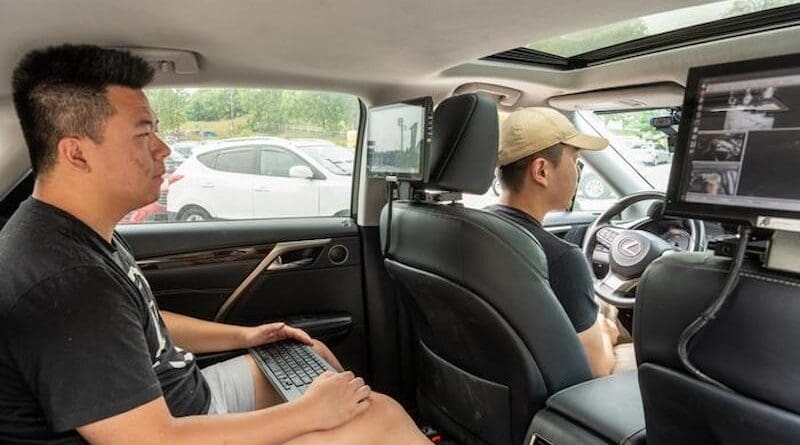 While study participants sat in the driver’s seat of the test autonomous vehicle and spoke commands, a Purdue researcher sat in the back to monitor the large language models and feeds from the vehicle’s cameras. Pictured from back to front of the vehicle: Purdue master’s student Yupeng Zhou and PhD student Can Cui. CREDIT: Purdue University photo/John Underwood
