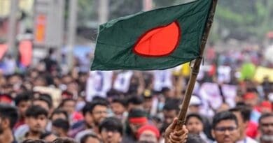 Protestors with the Bangladesh flag. Photo Credit: Tasnim News Agency