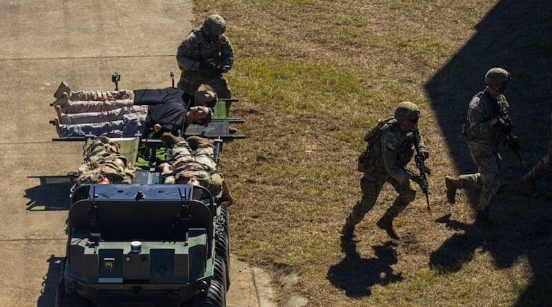Soldiers of the Maneuver Center of Excellence Experimental Company, 1st Battalion, 29 Infantry Regiment, 316th Cavalry Brigade, employ integrated robotics during a simulated operation as attendees of the Human Machine Integration Summit II view. (U.S. Army photo by Denise Mosley)