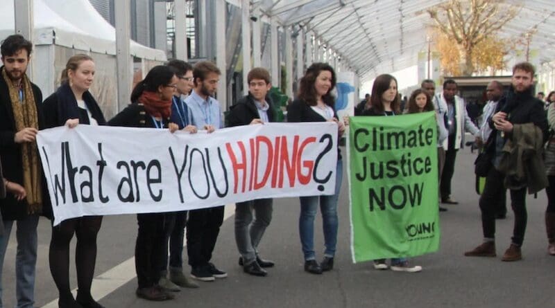 Youths in a loss and damage demonstration during COP21 in 2015. Climate finance will be the central focus of talks at COP29 in Baku, Azerbaijan. Copyright: John Englart (CC BY-SA 2.0). This image has been cropped.
