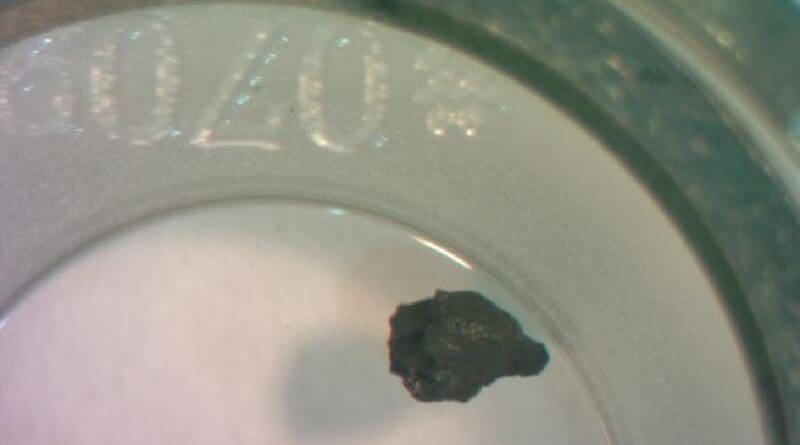MIT scientists analyzed one of several particles (shown in black) from the asteroid Ryugu, and found evidence that a weak magnetic field likely existed in the outer solar system where the asteroid is thought to have first formed, more than 4.6 billion years ago. CREDIT: Elias Mansbach
