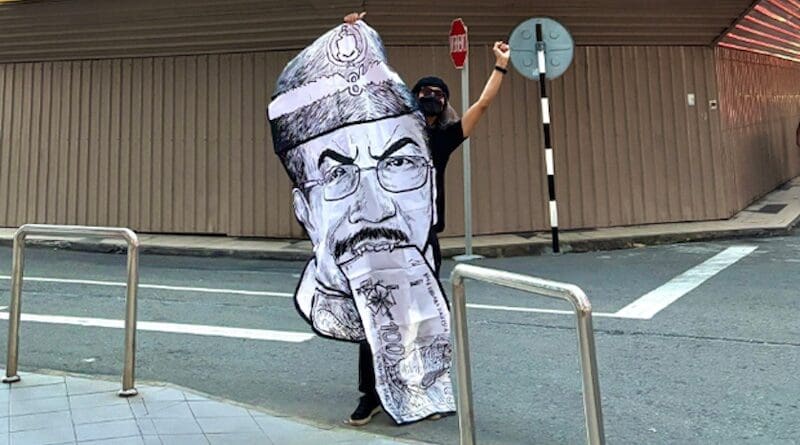 In this photograph posted on his Instagram account, Malaysian satirical artist Fahmi Raza stands with a copy of his caricature of Musa Aman, whose term as Sabah state’s governor begins Jan. 1, 2025, in the state capital Kota Kinabalu, in Malaysian Borneo, Dec. 30, 2024 . Via X @kuasasiswa