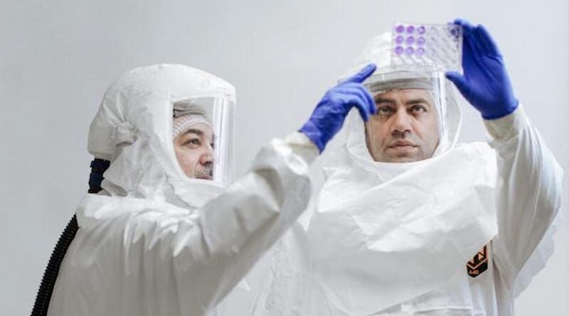 Professor Luis Martinez-Sobrido, Ph.D., (left) and Staff Scientist Ahmed Mostafa Elsayed, Ph.D., (right) review test results for the presence of bird flu while wearing protective equipment required for biosafety level-3 laboratories. CREDIT: Texas Biomed