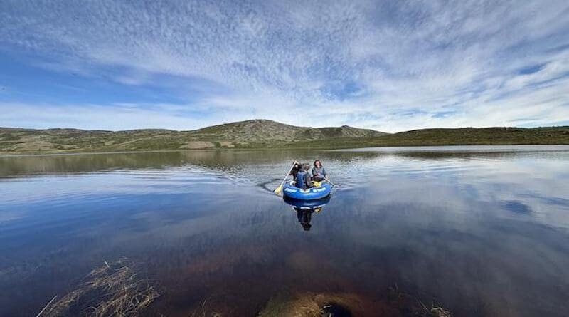 Researchers sample a lake near Kangerlussuaq, Greenland, that browned after the extreme events. CREDIT: Photo by Adam Heathcote