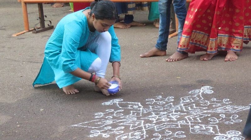 Example of a Kolam being drawn in Tamil Nadu, India. Photo Credit: Vinayaraj, Wikipedia Commons