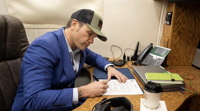 Defense Secretary Pete Hegseth signs a memorandum to rename Fort Liberty, N.C., to Fort Bragg, while aboard a military aircraft en route to Germany, Feb. 10, 2025. Army Pfc. Roland Bragg was awarded the Silver Star for conspicuous gallantry and intrepidity while serving with the 17th Airborne Division during World War II. Photo Credit: Navy Petty Officer 1st Class Alexander Kubitza, DOD