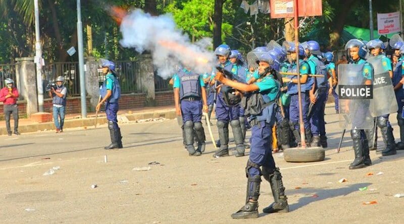 A police officer fires tear gas at protesting students as police disperse their gathering following a funeral prayer in absentia at the Dhaka University campus, July 17, 2024. Photo Credit: Mehedi Rana/BenarNews