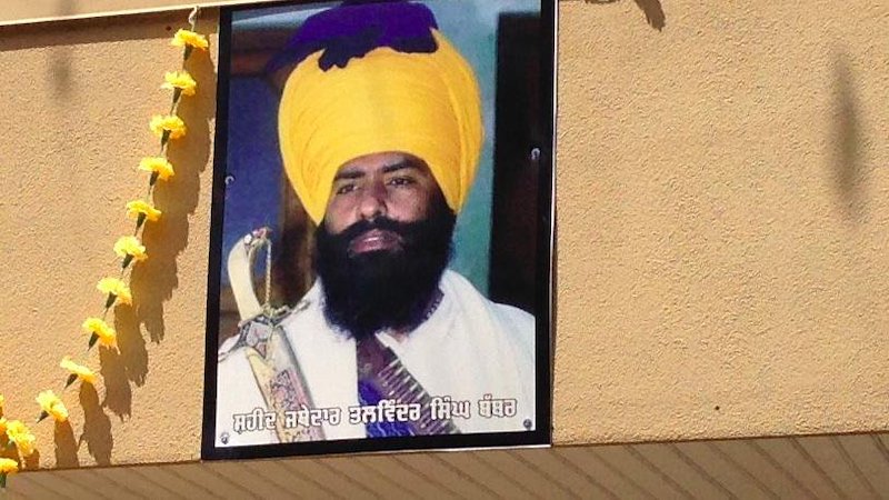 “Martyr” poster of Air India bomber Talwinder Singh Parmar, fixed to the exterior of the Dasmesh Darbar gurudwara in Surrey, British Columbia. The same photo, taken at a Pakistani gun market in 1989, was used by Sikhs for Justice to advertise its “Shaheed Talwinder Singh Parmar Voter Registration Centre.”