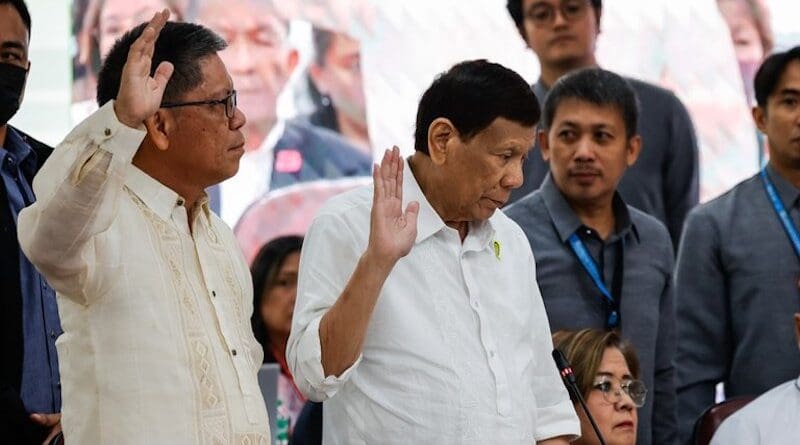 Former Philippine President Rodrigo Duterte takes oath beside former Philippine Sen. Leila de Lima, during the House Quad Committee hearing investigating his administration’s war on drugs, at the House of Representatives in Quezon City, Metro Manila, Nov. 13, 2024. (Gerard Carreon/BenarNews)