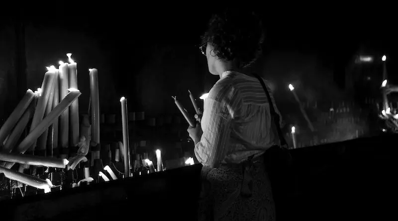 catholic church candles pray woman