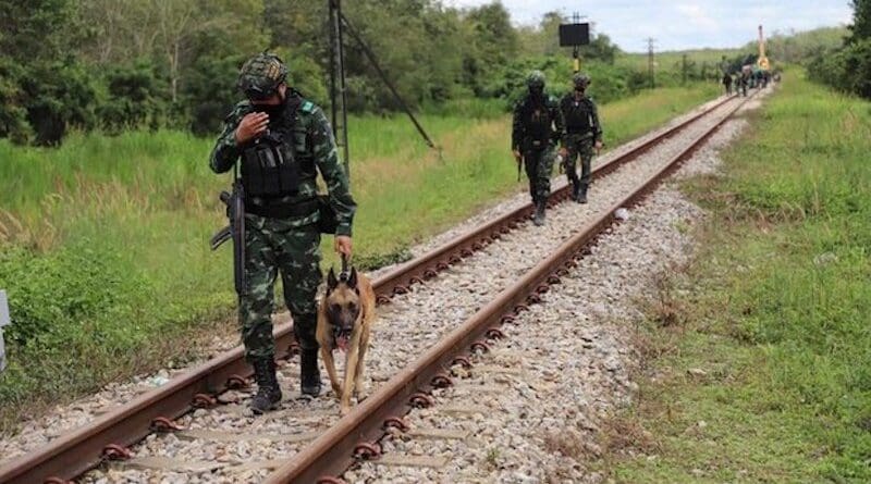 A soldier walks a sniffer dog along train tracks following a deadly explosion in Songkhla province, southern Thailand, Dec. 6, 2022. Photo Credit: BenarNews