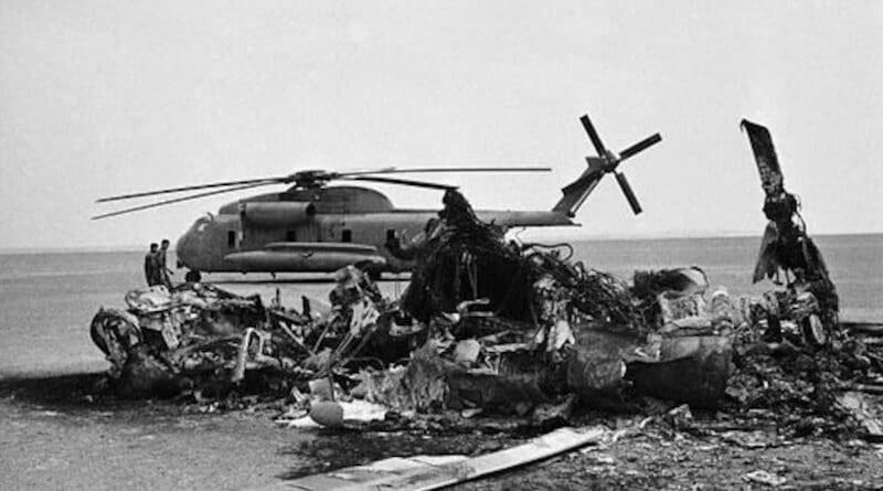 Wreckage of a Navy RH-53D helicopter is in front of an abandoned Navy RH-53D helicopter, at the site in the Iran desert where a hostage rescue attempt by the U.S. military was made, April 24, 1980. Photo Credit: Courtesy of Bahram Mohammadifard, DOD
