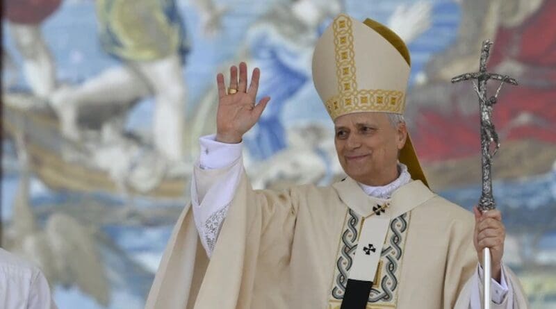 Pope Leo XIV waves during the inaugural Mass of his pontificate, held in St. Peter's Square on May 18, 2025. He stands in front of a Flemish tapestry depicting the dialogue between Jesus and Peter after the miraculous catch of fish. | Credit: Vatican Media