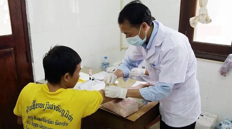 A patient gets his blood taken for a check at the hospital in Luang Prabang, Laos. The nation is one of those Southeast Asian countries expected to miss the 2030 health-related SDG targets. Copyright: Adri Berger/ILO. (CC BY-NC-ND 2.0)
