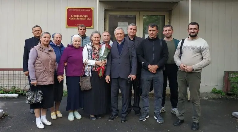 Vladimir Rudomyotkin and his wife Yelena (holding flowers) with church members, Budennovsk Inter-District Court, Donetsk, 15 May 2025 Photo Credit: Baptist Council of Churches