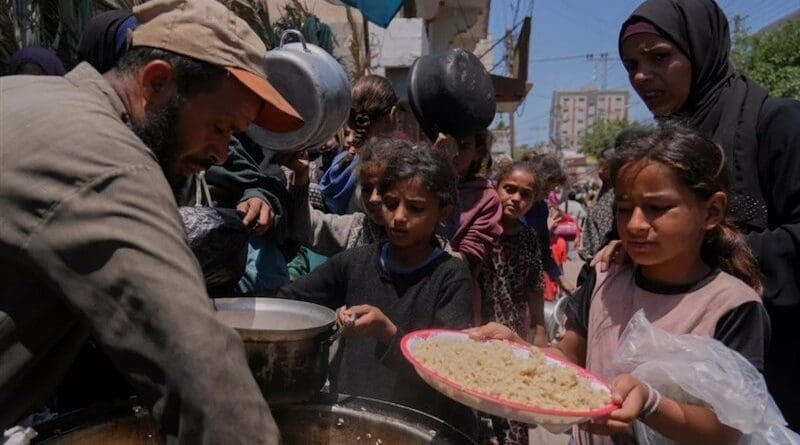 Gazans lining up for food. Photo Credit: Tasnim News Agency