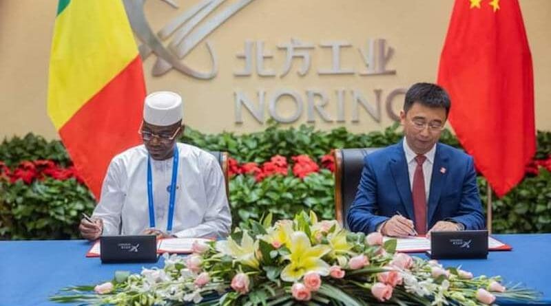 Col. Assimi Goïta, Mali’s junta leader, signs agreement with Norinco in Beijing. Photo Credit: Norinco