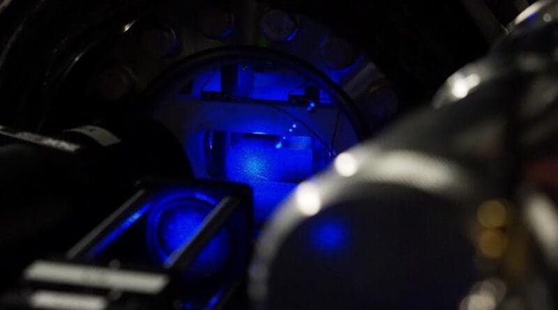 The small glowing ball in the centre of this chamber is a cloud of atoms at close to absolute zero, levitating on blue laser light. These atoms will be cooled even further before becoming tiny sensors, turned to listen for gravitational waves and dark matter CREDIT: Dr Thomas Walker, Imperial College London